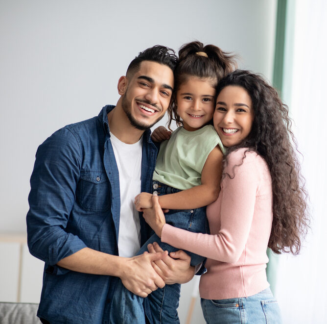 happy young family with two parents and one daughter