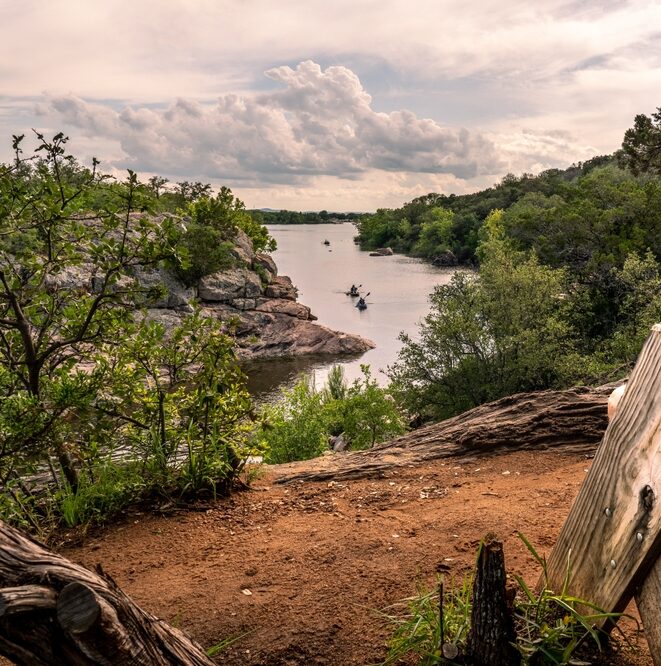 outdoor hiking area in Texas with water, trees, and sand