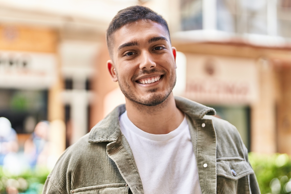 happy, smiling man outside addiction recovery center